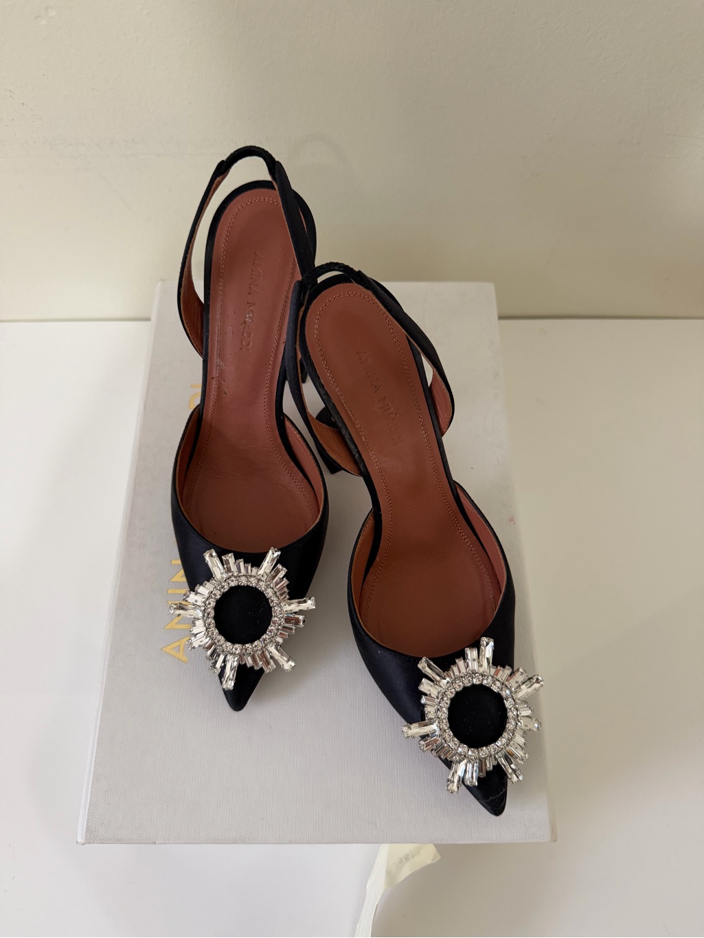 Amina Muaddi Black Satin Pointed Slingback Pumps With Crystal Sunburst